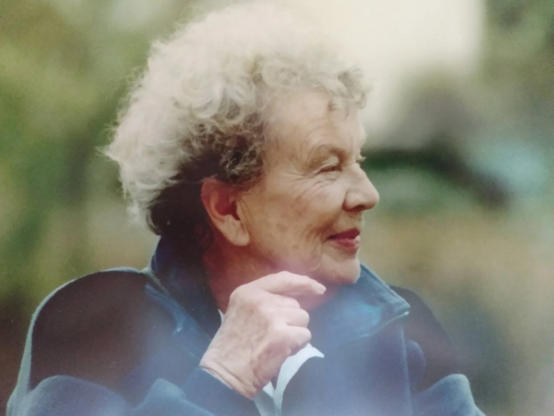 An elderly woman with curly gray hair